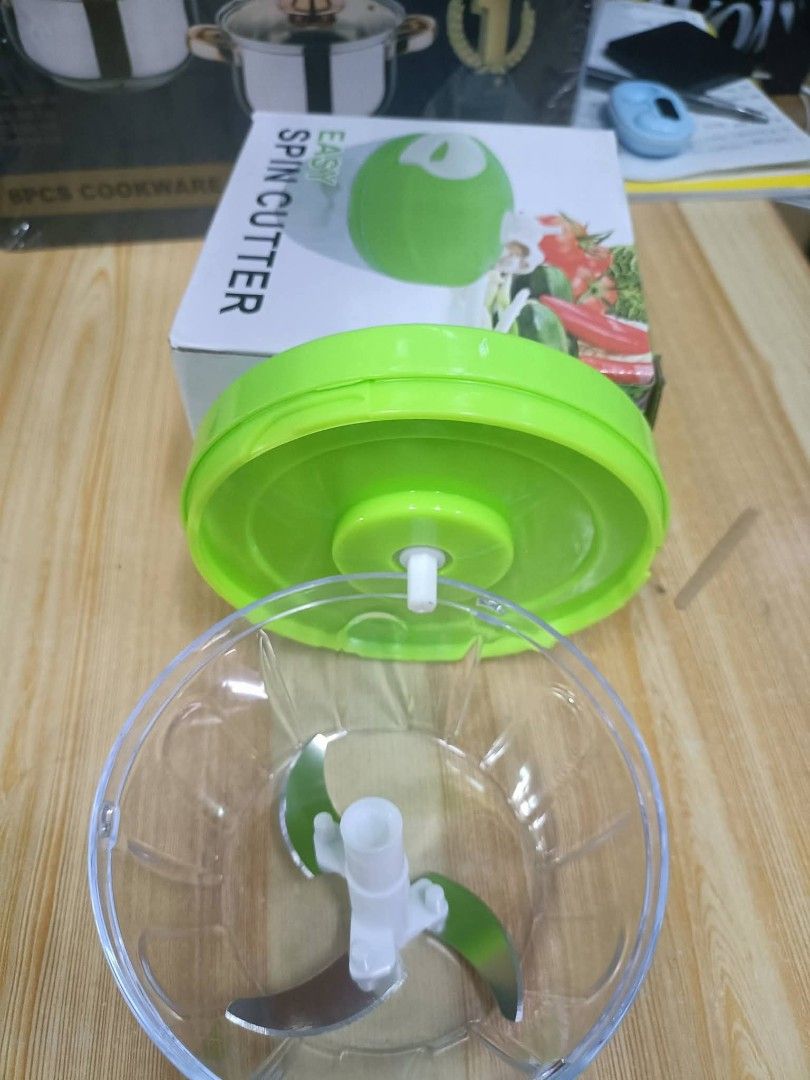 Easy Spin Cutter (Category: Cookware & Accessories) located in Manila. Submitted by yzlshop (Listing ID 1427184123, Image 2). Description: Easy Spin Cutter is a handy kitchen tool for chopping vegetables and other ingredients. It features a green lid and a clear bowl with a blade. The box shows the product's name and a picture of chopped vegetables. It's a convenient way to prepare food quickly..