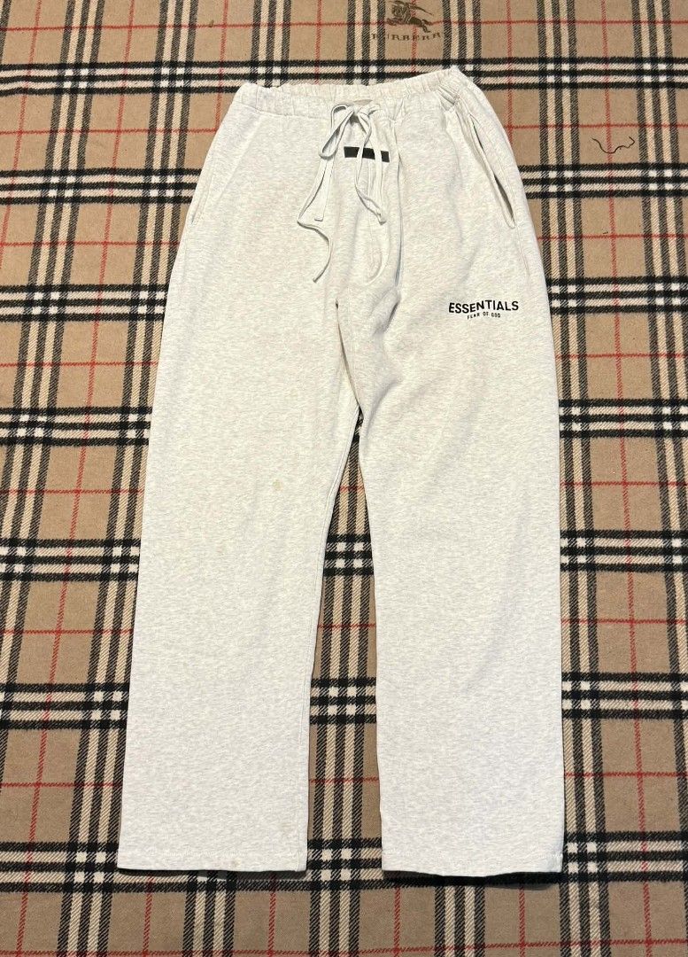 Essentials Sweatpants (Category: Joggers) located in Cavite. Submitted by markjoseph24866 (Listing ID 1427217971, Image 1). Description: Gray Essentials sweatpants. Features a drawstring waistband and the Essentials logo on the left leg. Includes pockets. The pants appear to be made of a soft, comfortable material..