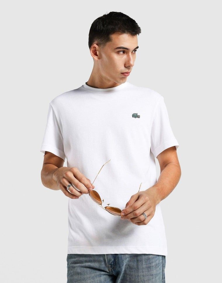 FREE SHIPPING EXCLUSIVE Lacoste White T-Shirt (Category: Tshirts & Polo Shirts ) located in Quezon City. Submitted by wcfhomeandoffice (Listing ID 1427312826, Image 1). Description: This cotton blend jersey T-shirt features a classic crew neck and short sleeves for everyday comfort, finished with a front silicone logo patch for a sleek, sporty touch. Care & Material: 65% cotton, 35% polyester Colour: White.
