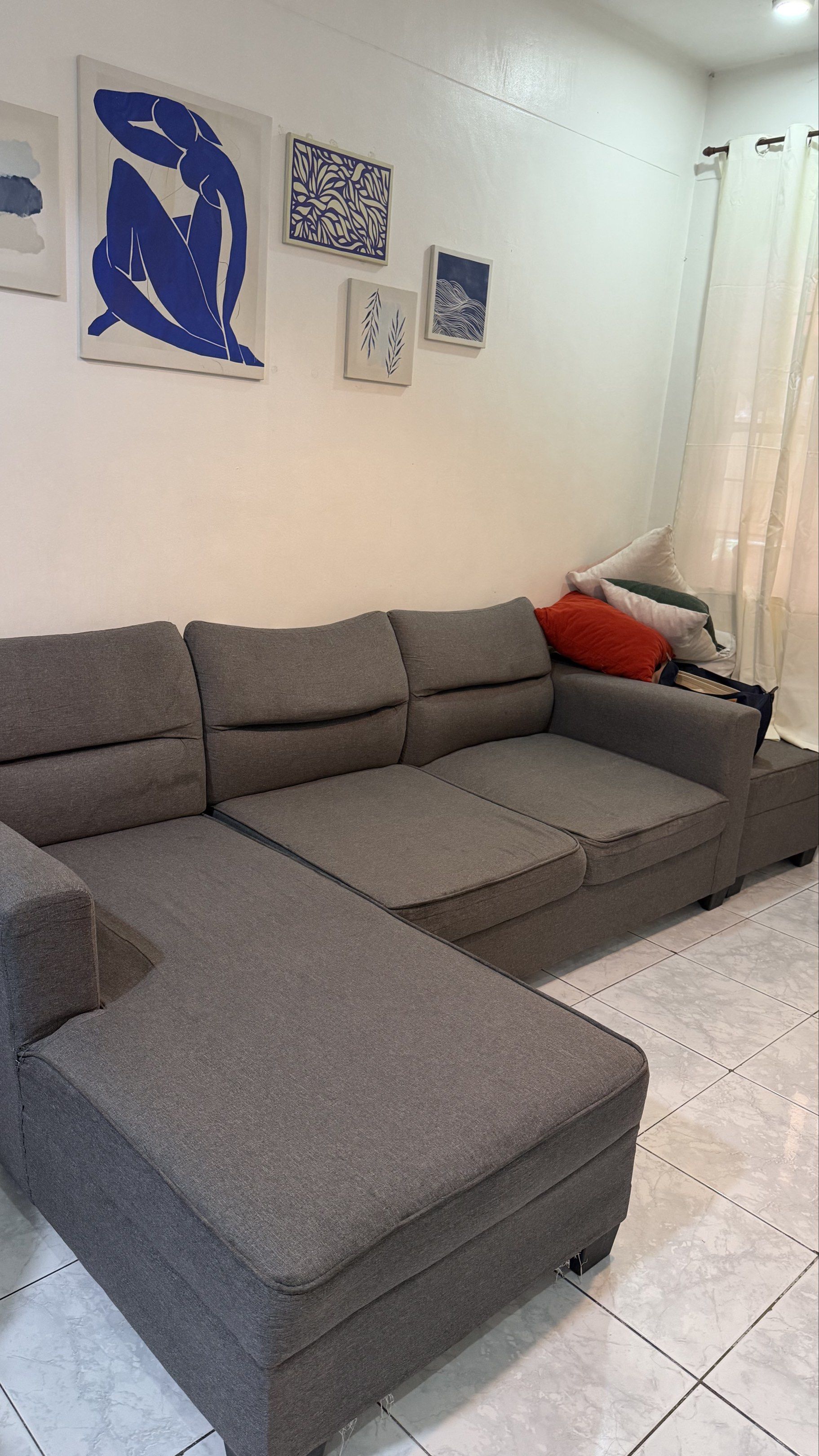 Gray Sectional Sofa with Chaise (Category: Sofas) located in Quezon City. Submitted by racollo (Listing ID 1427184154, Image 1). Description: Furniture Deals L-shape Sofa (Bought 2023) Original Price : 26,500 Selling Price : 10,000 Condition : Well used, uratex foam but manipis lang. 4 seaters. Flaws : tastas sa ilalim, lubog na yung foam sa gitna, stretch na yung foam near arm rest. RFS : Moving to a smaller house, hindi na kasya. 📍San Mateo, R