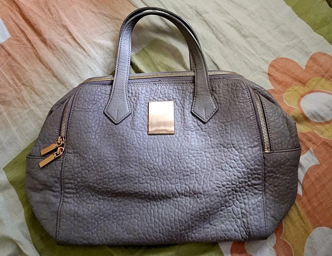 Grey Handbag with Gold Accents (Category: Luxury Bags & Wallets) located in Paranaque City. Submitted by dacucs.24 (Listing ID 1427264134, Image 1). Description: -OG COURRONE -GREY -2,000 .