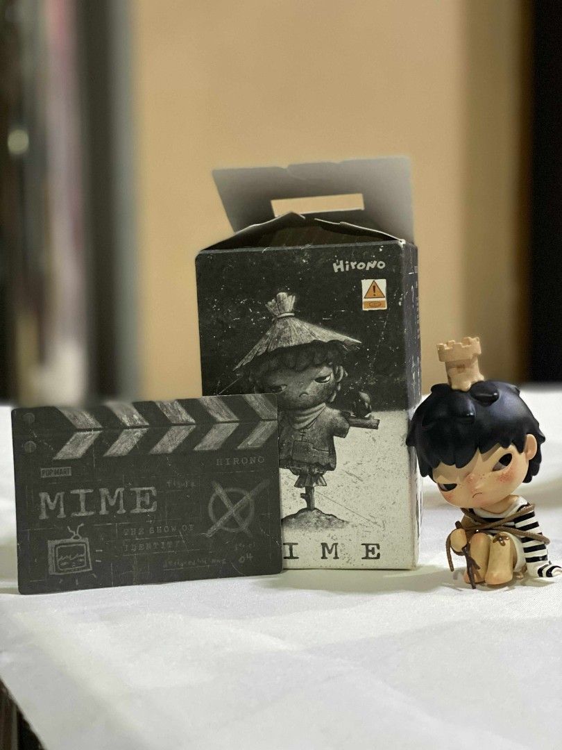 Hirono Prisoner from Mime Series (Category: Designer & Blind Box Toys) located in Manila. Submitted by dala.collection (Listing ID 1427228863, Image 1). Description: Hirono Mime figurine comes with its original box and a clapperboard. The figurine depicts a seated figure with a crown. The box features an illustration of a character with a hat. The clapperboard is marked with the word "Mime"..