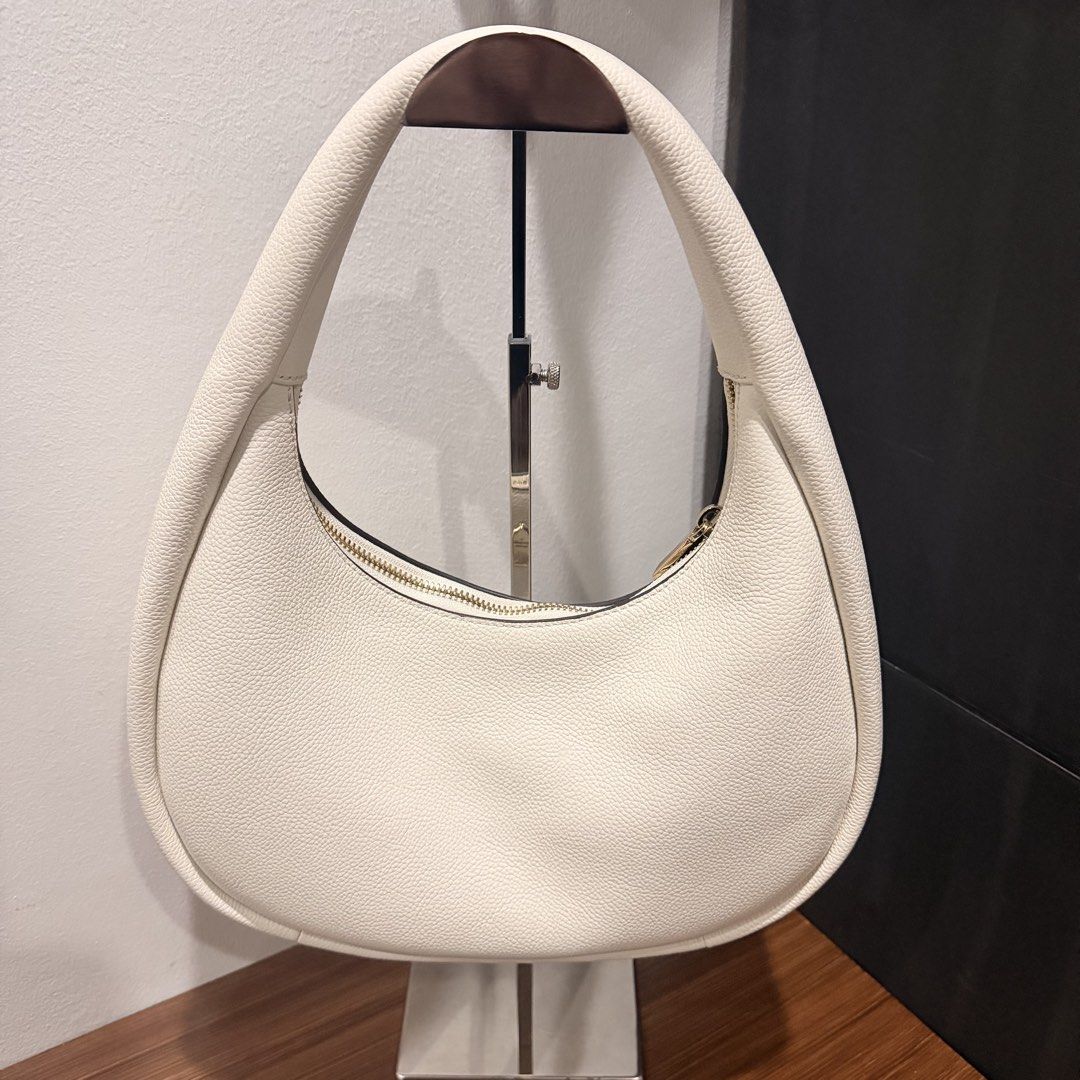 Kate Spade Cream Shoulder Bag (Category: Luxury Bags & Wallets) located in San Pedro. Submitted by love.bruce10 (Listing ID 1427275087, Image 2). Description: Cream-colored shoulder bag from Kate Spade. Features a gold zipper and a gold spade logo. The interior is cream-colored. The bag has a rounded shape and a single shoulder strap. The bag is new with tags. Used a few times only, bought in the US.