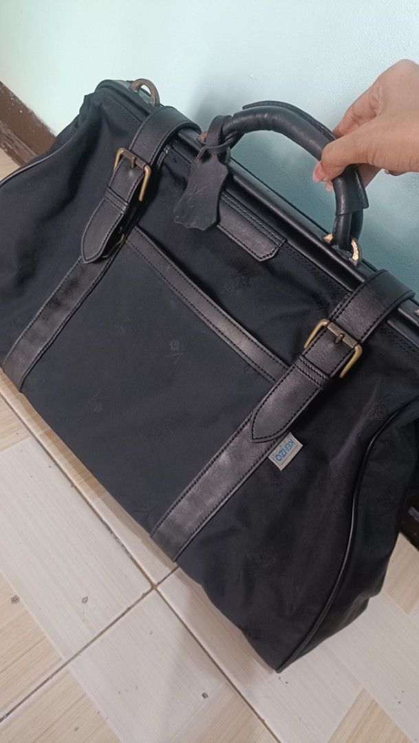 Kenzo Paris Duffle Bag (Category: Luxury Bags & Wallets) located in Las Pinas. Submitted by sarahlayan25584 (Listing ID 1427202402, Image 1). Description: Black duffle bag from Kenzo Paris. Features leather accents, a top handle, and a shoulder strap. Includes a main compartment and an interior pocket. The bag has a zipper closure with a branded zipper pull. The Kenzo Paris label is visible inside the bag. The bag has some signs of wear. -Replace