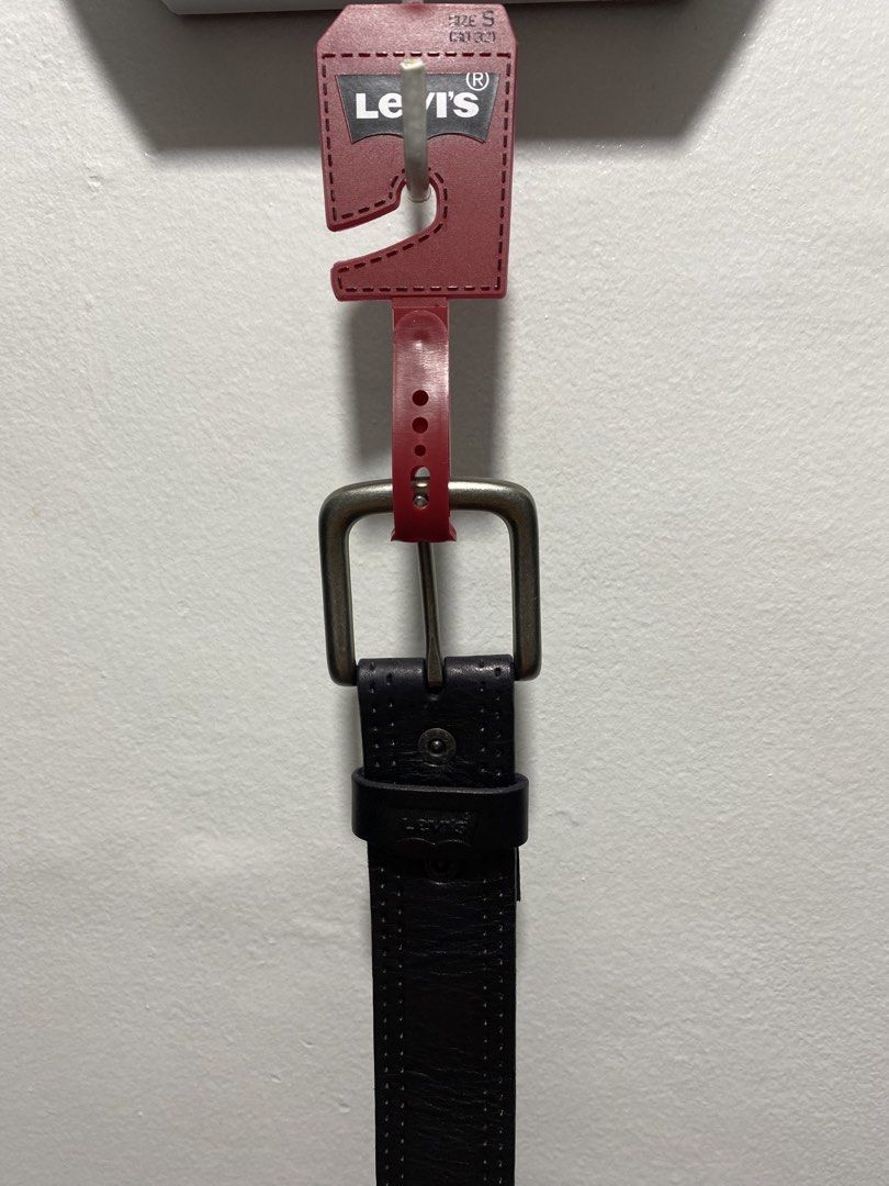 Levi's Black Leather Belt (Category: Belts) located in Cagayan de Oro. Submitted by cu_2022 (Listing ID 1427299597, Image 1). Description: Genuine Levi's black leather belt. Features a silver buckle and a perforated design. The size is SM, fitting waist sizes 30-32. The belt has the Levi's logo embossed on the leather. The style code is 11LV120Z28. Made of leather..