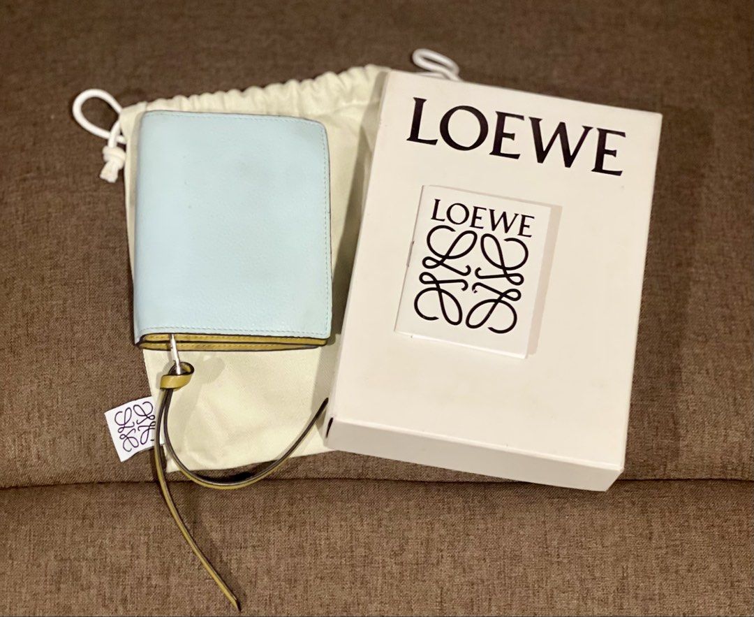 Loewe Bifold Wallet (Category: Luxury Bags & Wallets) located in Muntinlupa City. Submitted by jnjsluxury (Listing ID 1427216626, Image 2). Description: - Authentic Loewe bifold wallet - Light blue exterior with yellow accent - Yellow interior - Features card slots and zippered compartment - Includes original box, dust bag, and tags - Made in Spain Price is slightly negotiable Shipping via lalamove .