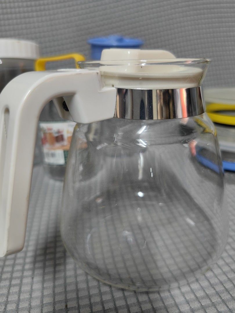 Melitta Glass Coffee Server (Category: Coffee & Tea Tableware) located in Rizal. Submitted by gkstcenit (Listing ID 1427165020, Image 2). Description: Melitta coffee server features a clear glass body with a white handle and lid. It has a stainless steel band around the top and a measurement scale on the side. The lid has a white plastic piece for pouring..