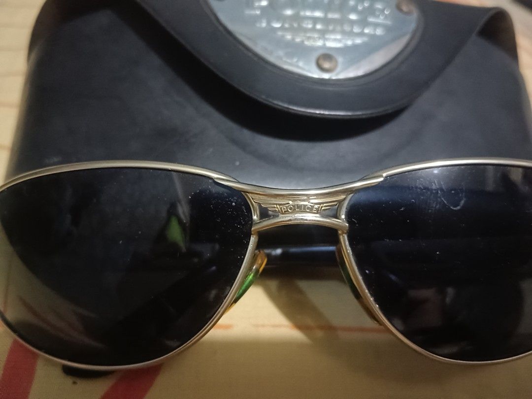 Police Sunglasses 2357 (Category: Sunglasses & Eyewear) located in Caloocan City. Submitted by jee2727 (Listing ID 1427273148, Image 3). Description: Stylish Police sunglasses with a silver frame and dark lenses. Includes the original case. The model number is 2357. The sunglasses are marked "Made in Italy". The case has the Police logo on it. The sunglasses have a sleek, modern design..