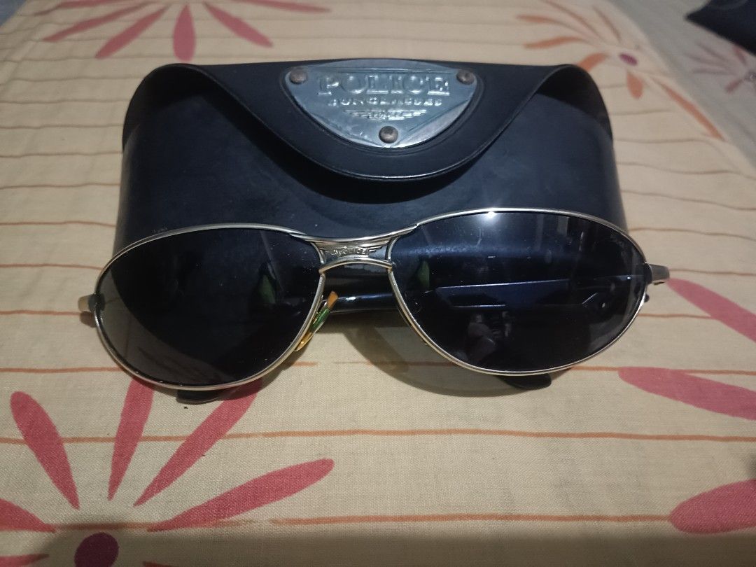 Police Sunglasses 2357 (Category: Sunglasses & Eyewear) located in Caloocan City. Submitted by jee2727 (Listing ID 1427273148, Image 1). Description: Stylish Police sunglasses with a silver frame and dark lenses. Includes the original case. The model number is 2357. The sunglasses are marked "Made in Italy". The case has the Police logo on it. The sunglasses have a sleek, modern design..