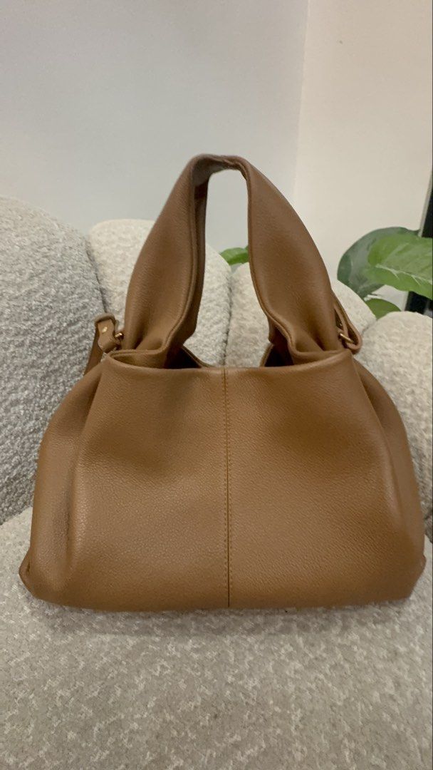 Polène Numéro Sept Mini Handbag (Category: Luxury Bags & Wallets) located in Caloocan City. Submitted by dyowanajav18292 (Listing ID 1427219051, Image 2). Description: Polène Numéro Sept Mini handbag in a taupe color. It features a top handle and a flap closure. The bag has a detachable shoulder strap. The bag is sitting on a gray textured surface..