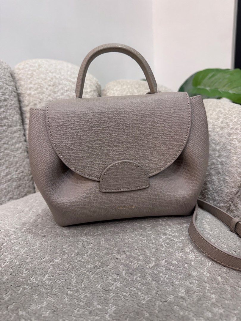 Polène Numéro Sept Mini Handbag (Category: Luxury Bags & Wallets) located in Caloocan City. Submitted by dyowanajav18292 (Listing ID 1427219051, Image 1). Description: Polène Numéro Sept Mini handbag in a taupe color. It features a top handle and a flap closure. The bag has a detachable shoulder strap. The bag is sitting on a gray textured surface..