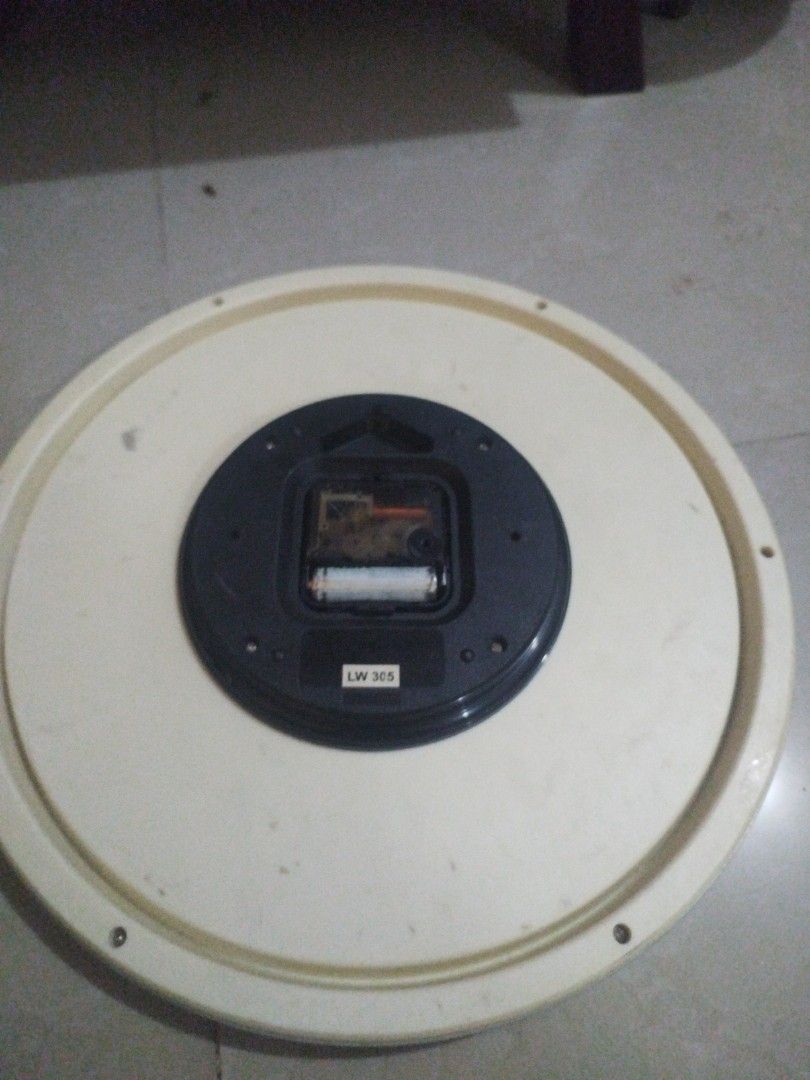 Casio Round Wall Clock (13 inches diameter) (Category: Clocks) located in San Rafael. Submitted by jflshoppe1989 (Listing ID 1427230285, Image 2). Description: Round wall clock. The back of the clock is visible, showing the battery compartment and the clock mechanism. The clock has a cream-colored frame. The clock mechanism has a label that says "LW 325"..