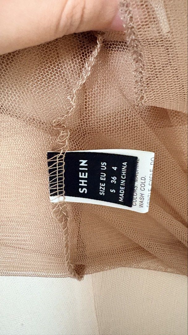 Shein Mesh Top - Size S (Category: Blouses) located in Mexico. Submitted by ivorybyfifth (Listing ID 1427190846, Image 2). Description: Shein mesh top in a neutral tan color. Features short sleeves and a round neckline. The tag indicates a size S. Made in China. A versatile piece that can be layered or worn on its own. Perfect for adding a touch of texture to any outfit..