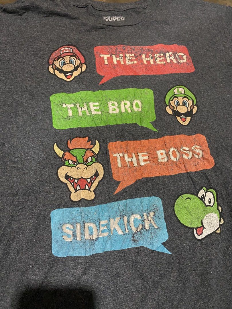 Super Mario Bros. Graphic T-Shirt - Large (Category: Tshirts & Polo Shirts ) located in Cavite. Submitted by jamstore89 (Listing ID 1427294907, Image 2). Description: Mario shirt 2018 nintendo Large 21"x 27.5" P400 Chips paint issue Super Mario Bros. t-shirt features a fun graphic with Mario, Luigi, Bowser, and Yoshi. It's a dark gray color and made of a cotton and polyester blend. The shirt is a size Large. Made in Honduras. The shirt has a dist