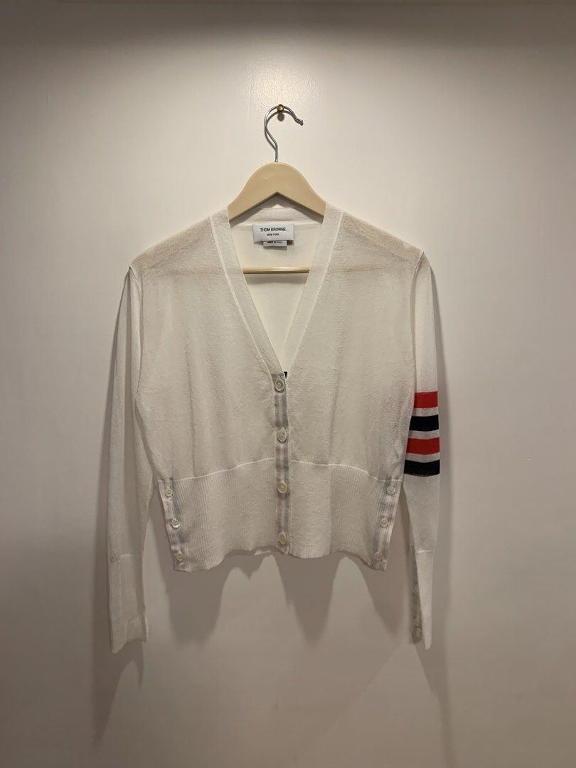 Thom Browne "White" 4-Bar Silk Cardigan (Category: Luxury Apparel) located in Bacolod City. Submitted by moboandmoga (Listing ID 1427211227, Image 1). Description: Thom Browne "White" 4-Bar Silk Cardigan Size: 36 Excellent Condition! (Sizing info) Width: 19 inches Length: 19.6" White cardigan from Thom Browne. Features a V-neck, button closure, and the brand's signature stripe detail on the left sleeve. Made in Italy. Size 36..