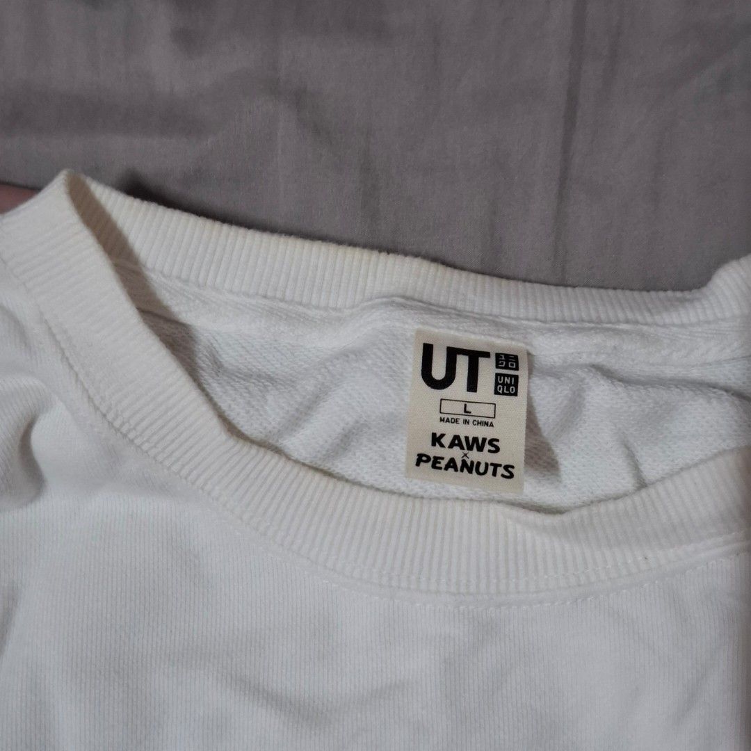 UNIQLO Kaws x Peanuts Snoopy Sweatshirt (Category: Longsleeves) located in Quezon City. Submitted by declutterwithnari (Listing ID 1427286797, Image 2). Description: - UNIQLO White Kaws x Peanuts Snoopy Crewneck Sweatshirt: in good condition! - The only issue is the minimal yellowing around the collar area. mop: GCash, GoTyme, Maya (payment first) mod: Lalamove, Grab, J&T (item + sf).