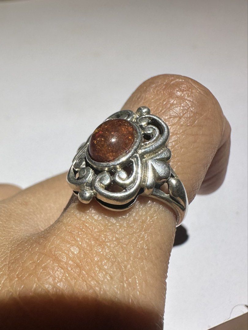 Vintage 925 Silver Baltic Amber Cabochon Stone Ring (Category: Rings) located in Mandaluyong City. Submitted by chyckenwings (Listing ID 1427287187, Image 3). Description: Vintage ring features an art nouveau style amber cabochon stone set in an ornate silver 925 metal. The ring has a detailed, scroll-like design around the stone. Slight chip on the gemstone possibly from old age which is common in amber since it's a relatively soft stone. Good i