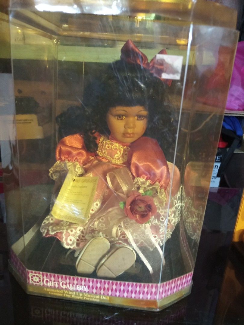 Vintage Assorted Dolls in Gift Gallery Doll in Boxes (Category: Vintage Collectibles) located in Marikina City. Submitted by picker_seller17 (Listing ID 1427206506, Image 2). Description: Collectible doll in a clear display case. The doll is wearing a red and gold dress with a matching bow. It has black hair and is holding a rose. The box has the Gift Gallery logo. The doll is in a clear plastic case..