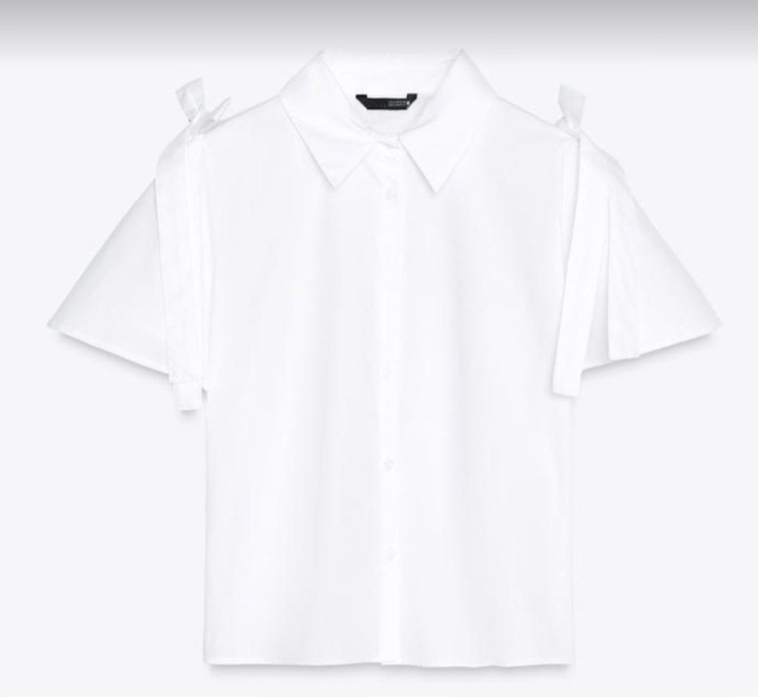 Zara White Shoulder Tie Blouse (Category: Blouses) located in Cainta. Submitted by Kamilerloo (Listing ID 1427251696, Image 1). Description: White blouse with short sleeves and shoulder ties. Features a collared neckline and button-down front. The blouse has a relaxed fit. Perfect for a casual yet stylish look. Poplin shirt with a ribbon detail from ZARA..