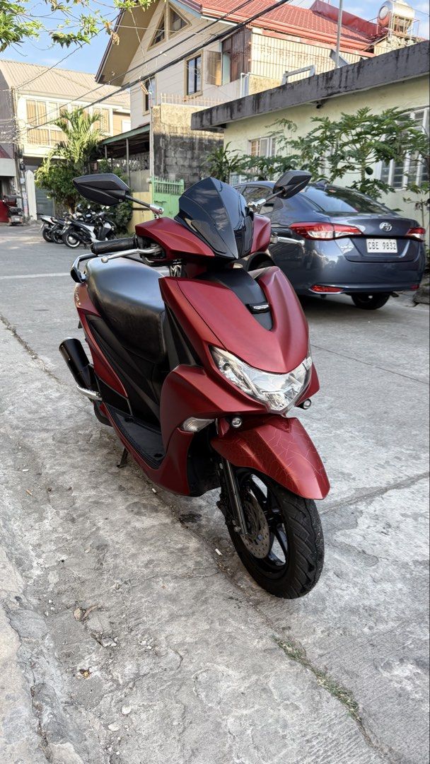 Yamaha Mio Gravis (Category: Motorbikes for Sale) located in Las Pinas. Submitted by jalani01 (Listing ID 1427232130, Image 2). Description: Maroon Yamaha Mio Gravis scooter 2020 Features a black seat, black wheels, and a black windshield. The scooter has a license plate number 293NPL. The scooter is parked on a concrete surface. mio gravis 125 2020 model color: matte red plate: 293NPL complete legal papers under my name complete 2keys all workin
