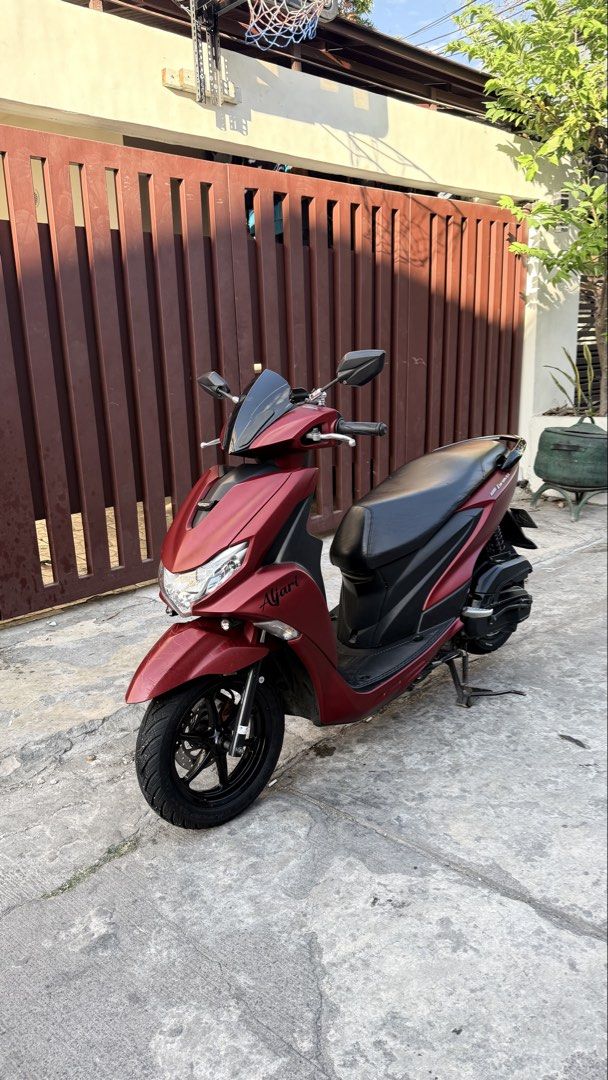 Yamaha Mio Gravis (Category: Motorbikes for Sale) located in Las Pinas. Submitted by jalani01 (Listing ID 1427232130, Image 1). Description: Maroon Yamaha Mio Gravis scooter 2020 Features a black seat, black wheels, and a black windshield. The scooter has a license plate number 293NPL. The scooter is parked on a concrete surface. mio gravis 125 2020 model color: matte red plate: 293NPL complete legal papers under my name complete 2keys all workin