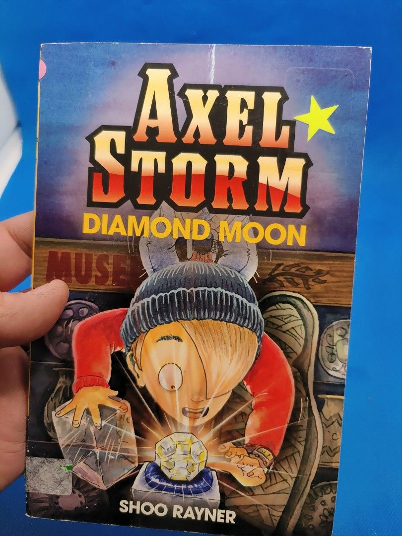 Axel Storm: Diamond Moon (Category: Storybooks) located in Quezon City. Submitted by angeleye7.authentic.source (Listing ID 1427409856, Image 1). Description: Book is titled "Axel Storm: Diamond Moon" by Shoo Rayner. It features a boy on the cover and the back of the book describes the story as Axel Storm helping his uncle on a top-secret mission to test the defenses of a new museum. Can Axel steal the priceless Diamond Moon without getting caugh