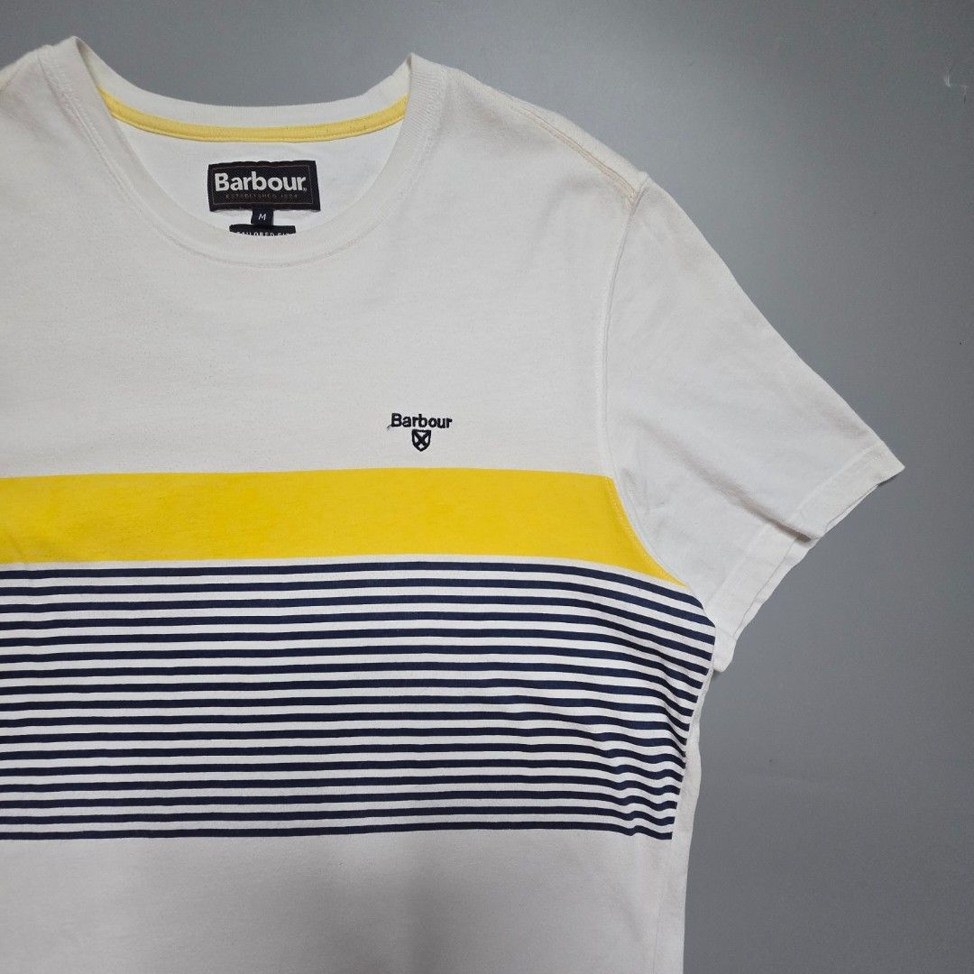 Barbour - Braeside Striped T-Shirt (Category: Tshirts & Polo Shirts ) located in Malabon City. Submitted by buynflex (Listing ID 1427470054, Image 3). Description: Braeside Striped Graphic T-Shirt Size M Dimes: W 20 x L 28 Used Good Condition Product Features Short sleeve Tailored fit Printed stripes to the front of the t-shirt Solid colour back Contrast Barbour and Shield embroidery to left chest 100% cotton 160gm Machine washable.