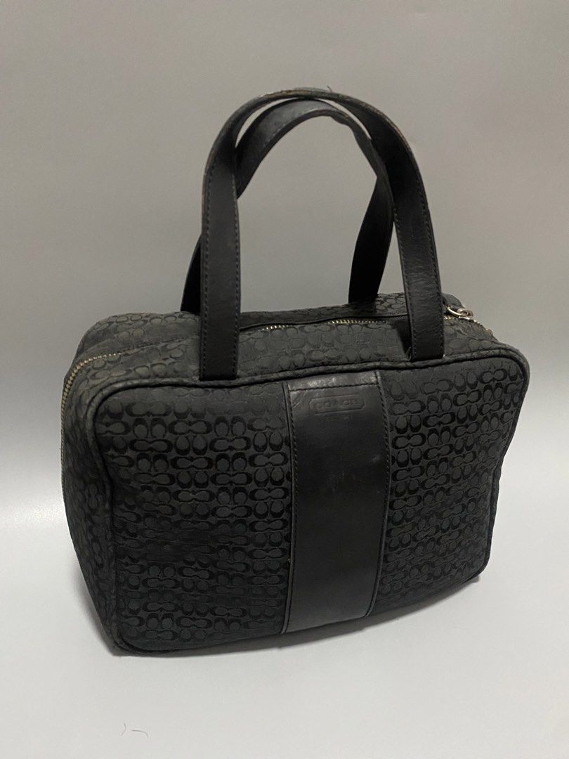 Coach Black Handbag (Category: Luxury Bags & Wallets) located in Manila. Submitted by owabaet12 (Listing ID 1427336481, Image 1). Description: Black Coach handbag with a signature pattern. Features dual top handles and a zip-around closure. The interior has multiple compartments for organization. The hardware is silver-toned. The bag has a rectangular shape..
