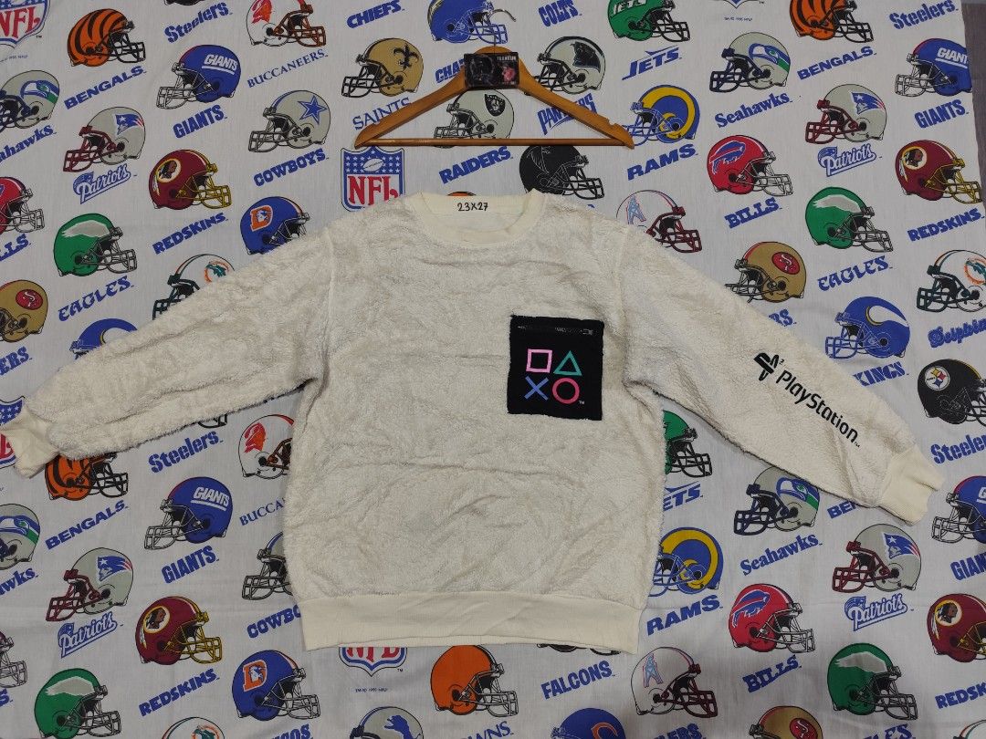 GU PlayStation Fleece Sweatshirt (Category: Coats, Jackets and Outerwear) located in Baguio. Submitted by FRANKLIN (Listing ID 1427379903, Image 1). Description: White fleece sweatshirt featuring a PlayStation logo pocket. The sleeve has the PlayStation logo printed on it. The size is L. The tag indicates the material is polyester, rayon, and nylon. The measurements are 23x27. Made by GU..