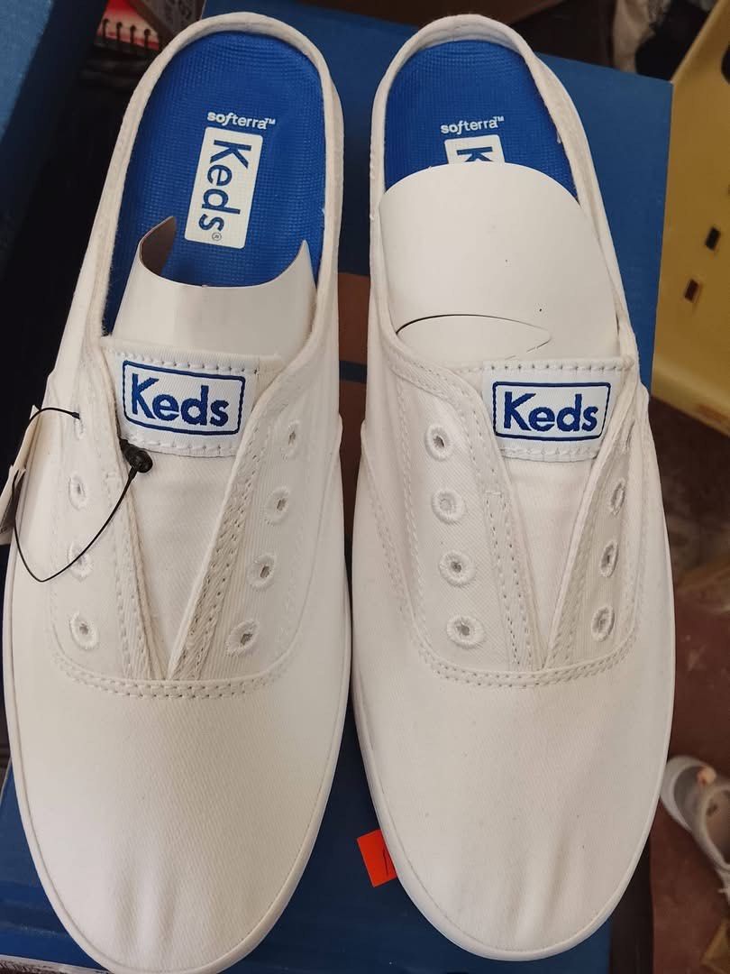Keds White Slip-On Sneakers (Category: Sneakers) located in Luna. Submitted by shoppesmith2020 (Listing ID 1427374308, Image 1). Description: Size 6.5 Brand New.
