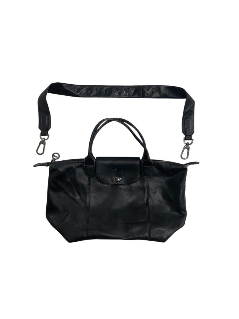 Longchamp Black Leather Handbag with Shoulder Strap (Category: Luxury Bags & Wallets) located in Borongan. Submitted by thrivory.ph (Listing ID 1427374523, Image 1). Description: - Longchamp black leather handbag. - Includes detachable shoulder strap. - Features Longchamp logo details. - Made in France. - Last 2 pics flaws.