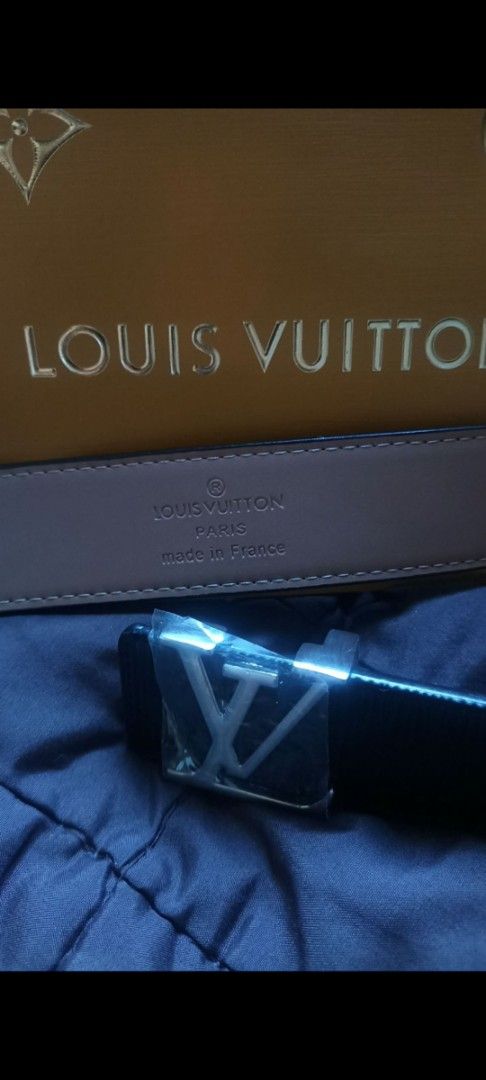Louis Vuitton Reversible Belt (Category: Belts) located in Kawit. Submitted by laraandrade (Listing ID 1427316868, Image 3). Description: Louis Vuitton reversible belt. Features a silver buckle with the LV logo. The belt is black on one side and brown on the other. Includes the original Louis Vuitton box and shopping bag. Made in France..