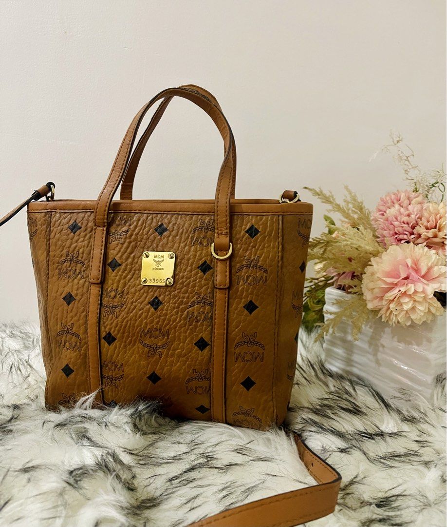 Mcm Toni Top Shopper Visetos Cognac (Category: Luxury Bags & Wallets) located in Teresa. Submitted by savvyonbranded (Listing ID 1427479385, Image 2). Description: 8 x 10 x 3 inches Minimal sign of use on handle Turnable screw, ykk zipper.
