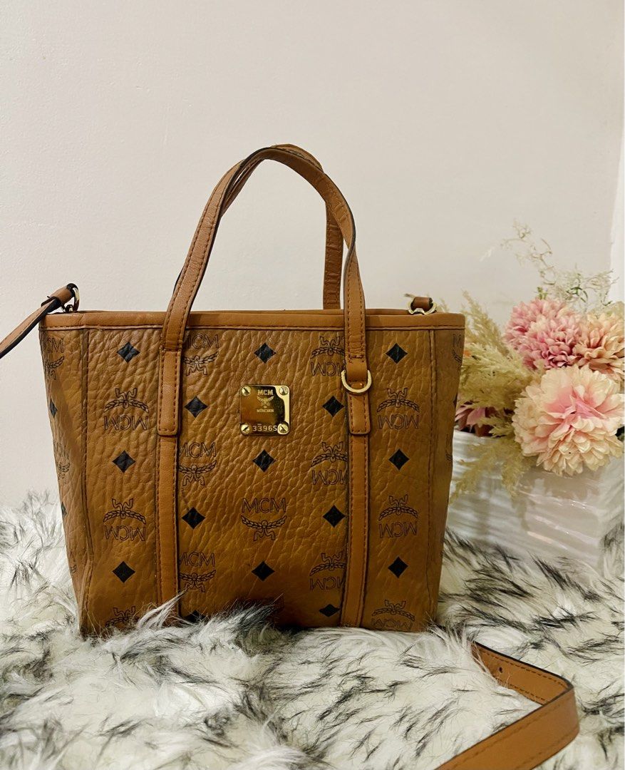 Mcm Toni Top Shopper Visetos Cognac (Category: Luxury Bags & Wallets) located in Teresa. Submitted by savvyonbranded (Listing ID 1427479385, Image 3). Description: 8 x 10 x 3 inches Minimal sign of use on handle Turnable screw, ykk zipper.