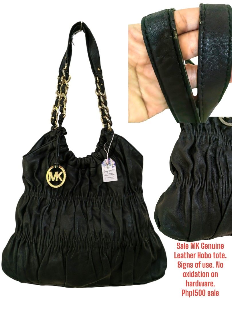 Michael Kors Genuine Leather Hobo Tote (Category: Luxury Bags & Wallets) located in Davao. Submitted by gelleevanelli (Listing ID 1427346161, Image 1). Description: Authentic Michael Kors hobo tote bag. Features a black leather exterior with gold-tone chain straps and a signature MK logo. The bag has a gathered design and a spacious interior. No oxidation on the hardware. The bag is on sale..