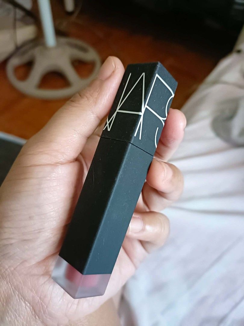 NARS Dolce Vita Lipstick (Category: Makeup) located in Calamba. Submitted by isabellaprimrose2.0 (Listing ID 1427373037, Image 1). Description: NARS lipstick in the shade Dolce Vita. The lipstick has a matte black rectangular tube with the NARS logo on the top. The bottom of the tube has the shade name and other details. The lipstick itself is a reddish-pink color..