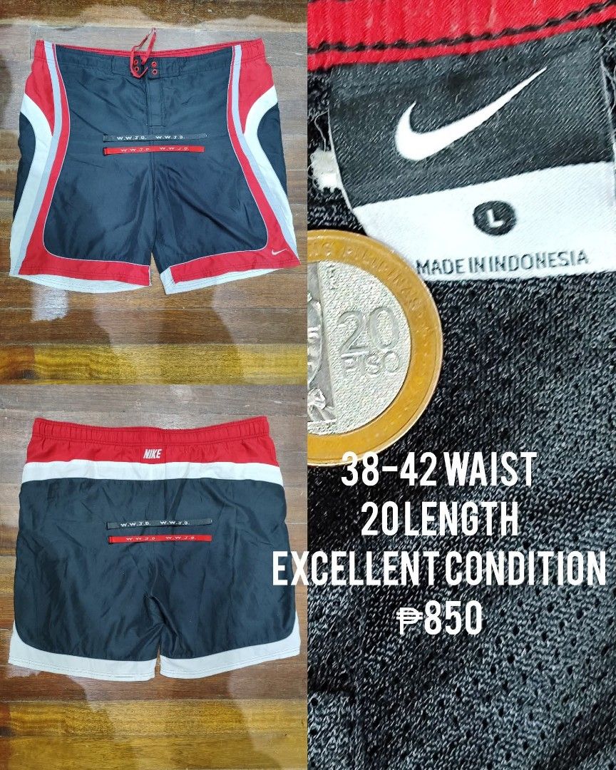 Nike Shorts - Size L (Category: Shorts) located in Quezon City. Submitted by trellzilla666 (Listing ID 1427425534, Image 1). Description: Nike shorts in size L. Features a black, red, and white color scheme. The shorts have a drawstring and a small pocket. Waist size is 38-42, and the length is 20. Made in Indonesia..