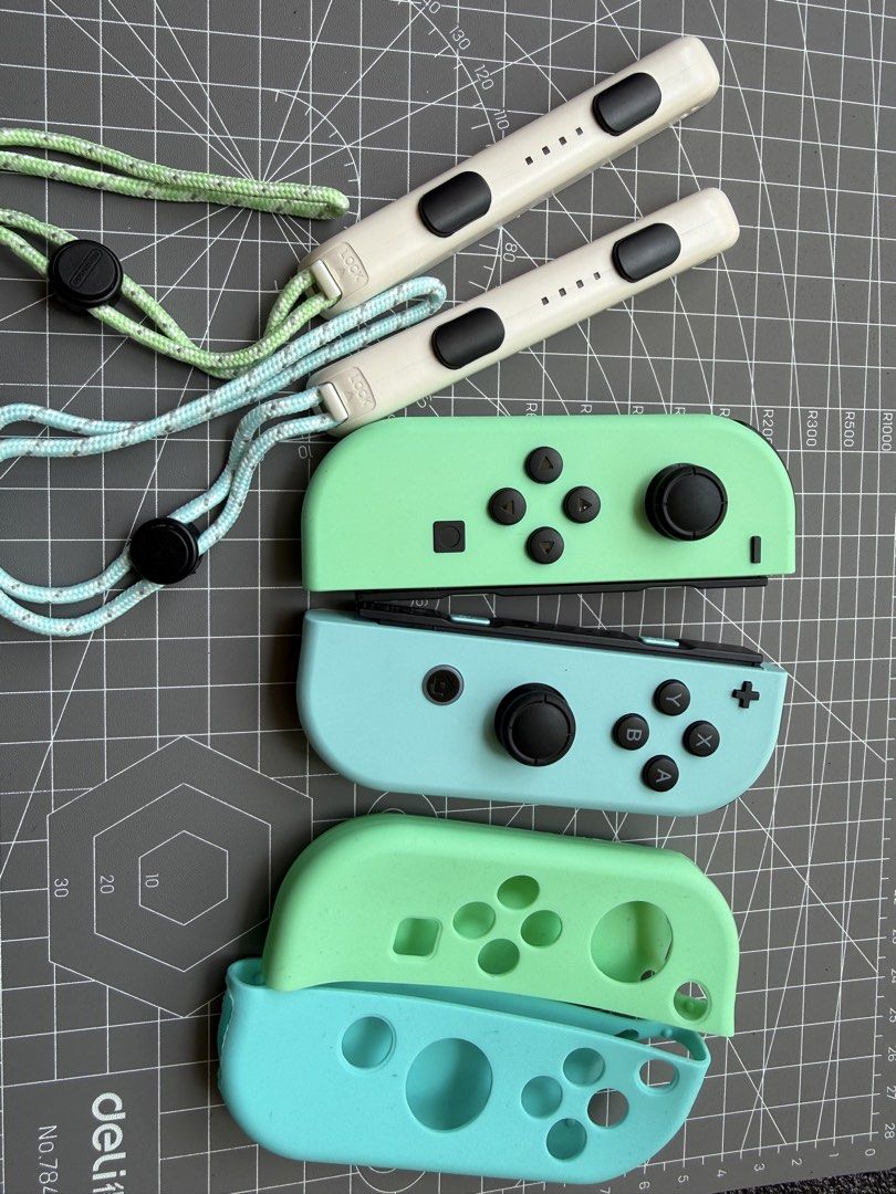 Nintendo Switch Joycon Animal Crossing (Category: Controllers) located in Makati City. Submitted by see5o5 (Listing ID 1427338690, Image 1). Description: Original Animal Crossing edition joycons. Mint condition, only used a couple of times and put away to preserve the condition. Includes the matching straps. Also included are TPU covers to protect the joycons. .