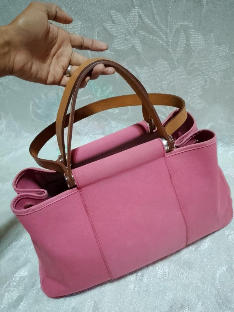 Original Hermes Pink Tote Bag (Category: Luxury Bags & Wallets) located in Tuguegarao City. Submitted by starzeke (Listing ID 1427475411, Image 2). Description: Pink tote bag with brown leather handles. Features a zipper closure and multiple interior compartments. The bag has a rectangular shape with a structured design. The handles are made of leather and are attached to the bag with metal hardware. The interior is also pink. The bag has a Herme