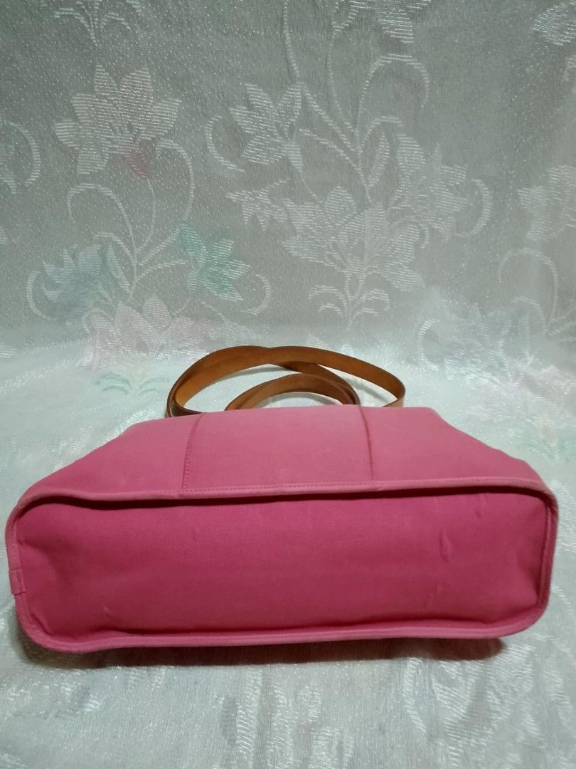 Original Hermes Pink Tote Bag (Category: Luxury Bags & Wallets) located in Tuguegarao City. Submitted by starzeke (Listing ID 1427475411, Image 3). Description: Pink tote bag with brown leather handles. Features a zipper closure and multiple interior compartments. The bag has a rectangular shape with a structured design. The handles are made of leather and are attached to the bag with metal hardware. The interior is also pink. The bag has a Herme