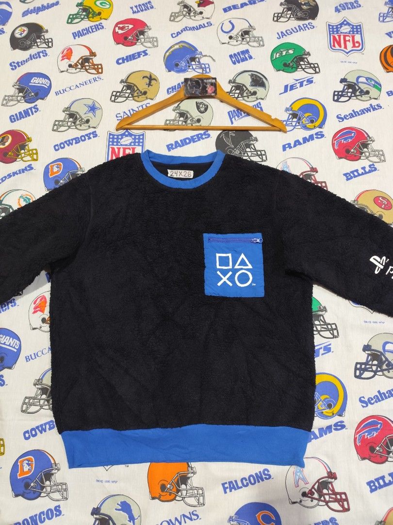 PlayStation Black Sweatshirt XL (Category: Coats, Jackets and Outerwear) located in Baguio. Submitted by FRANKLIN (Listing ID 1427379892, Image 2). Description: Black sweatshirt with blue accents. Features a PlayStation logo pocket and PlayStation text on the sleeve. The size is XL. The sweatshirt has a blue collar and cuffs. The back of the sweatshirt is plain black. The tag indicates the material composition..