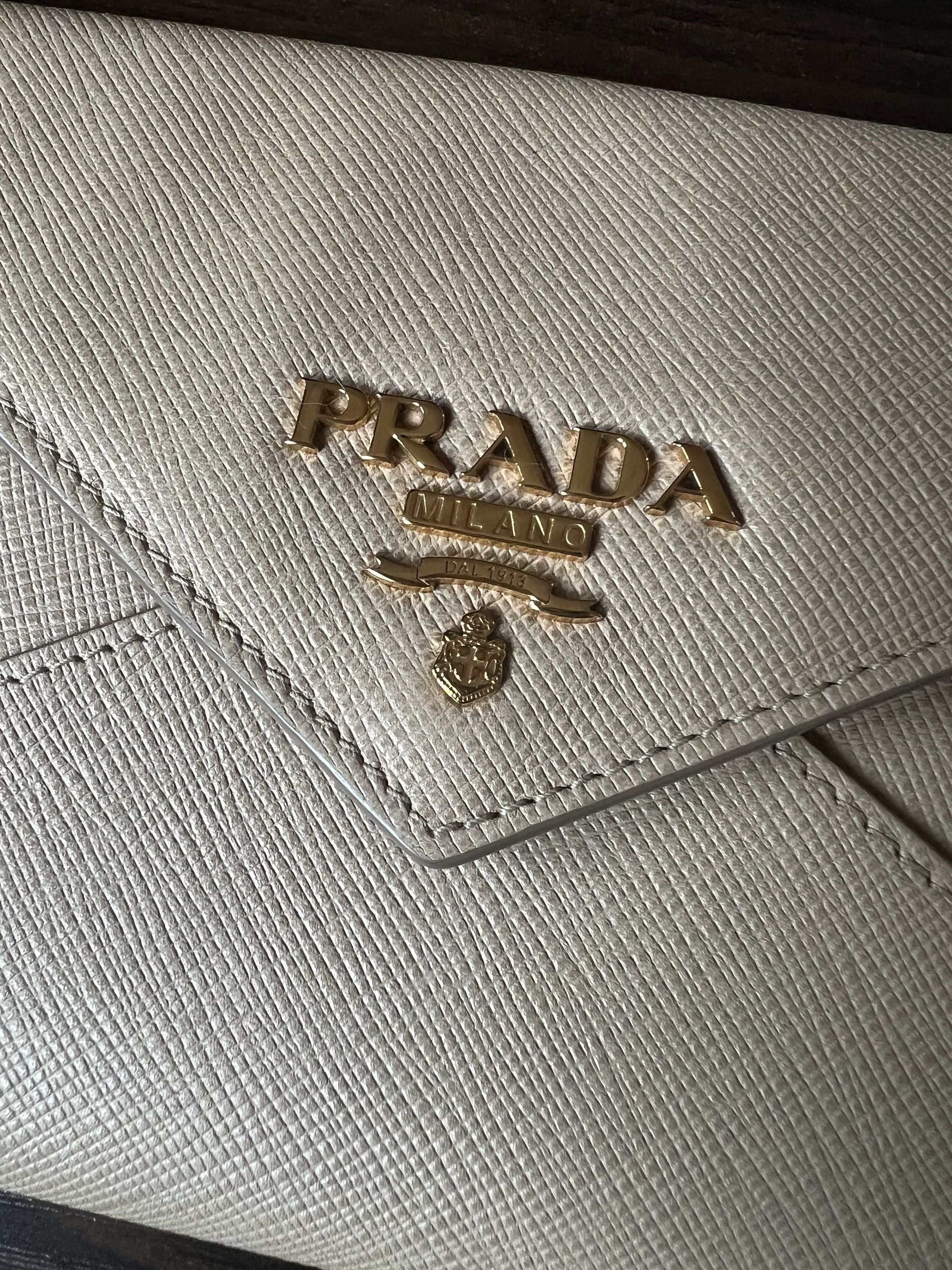 Prada Saffiano Envelope Wallet (Category: Luxury Bags & Wallets) located in Muntinlupa City. Submitted by thecatwalk (Listing ID 1427323924, Image 2). Description: Authentic Prada Saffiano Leather Envelope wallet in Beige With Authenticity cards Pre-loved in great condition No flaws 3 card inner pockets 1 outside zipper pocket Perfect for traveling, can fit passport, cash cards and coins. Super chic, sleek design .