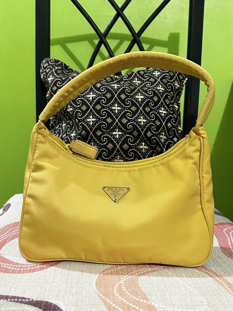 Prada Yellow Nylon Mini Hobo Baguette (Category: Luxury Bags & Wallets) located in Angeles City. Submitted by n_cln (Listing ID 1427452206, Image 2). Description: - guaranteed authentic vintage Prada mini bag in butter yellow (personal collection & one of my most favorites, also very pretty in person huhu 💛 & makes the whole fit. very chic and elegant pop of color) - no issues (just unnoticeable vintage marks/ very light soiling in the zipper & 