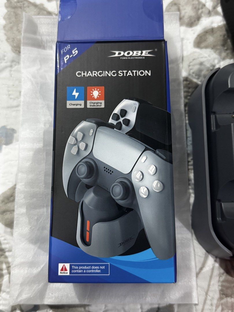 PS5 DualSense charging dock and silicone case (Category: PlayStation) located in Paranaque City. Submitted by gelato09 (Listing ID 1427446744, Image 2). Description: PS5 DualSense charging dock and silicone case Price: 300 FIXED Dobe charging dock for DualSense - complete packaging, used once, good as new Dobe silicone case for DualSense (2 pcs) - complete packaging, used once, good as new Pick up only at BF Homes Parañaque City. Buyer books and 