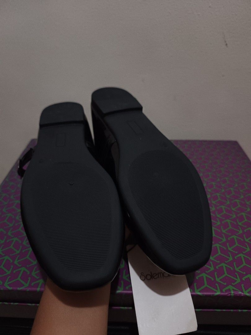 Solemate Black Mary Jane Shoes (Category: Flats & Sandals) located in Quezon City. Submitted by peralnorie53313 (Listing ID 1427442670, Image 3). Description: Black Mary Jane shoes from Solemate. Features a glossy finish and a strap with a buckle closure. The shoes have a round toe design. The shoes are new with tags..