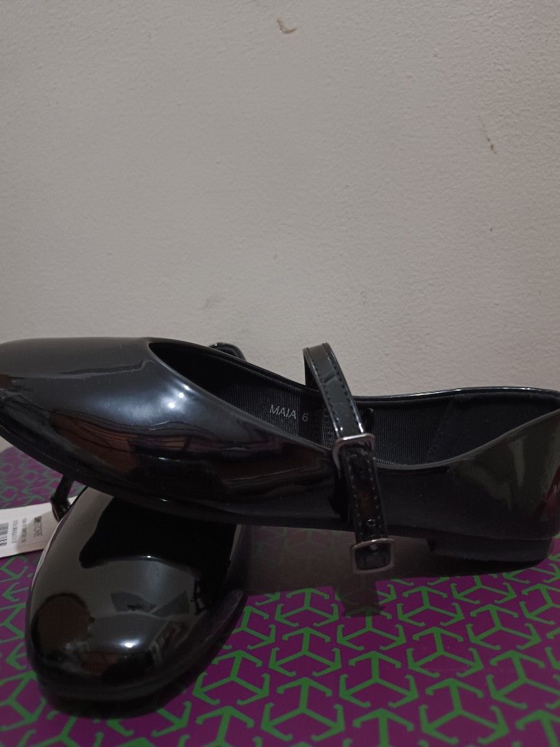 Solemate Black Mary Jane Shoes (Category: Flats & Sandals) located in Quezon City. Submitted by peralnorie53313 (Listing ID 1427442670, Image 2). Description: Black Mary Jane shoes from Solemate. Features a glossy finish and a strap with a buckle closure. The shoes have a round toe design. The shoes are new with tags..