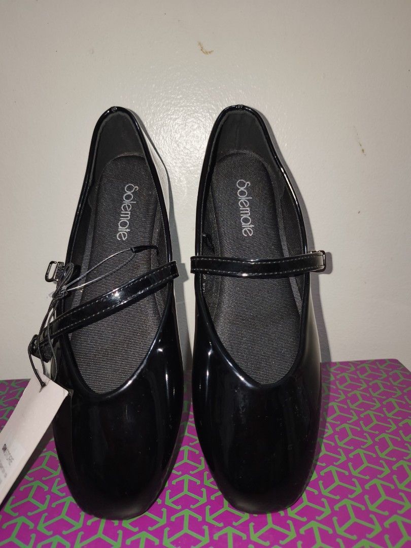 Solemate Black Mary Jane Shoes (Category: Flats & Sandals) located in Quezon City. Submitted by peralnorie53313 (Listing ID 1427442670, Image 1). Description: Black Mary Jane shoes from Solemate. Features a glossy finish and a strap with a buckle closure. The shoes have a round toe design. The shoes are new with tags..