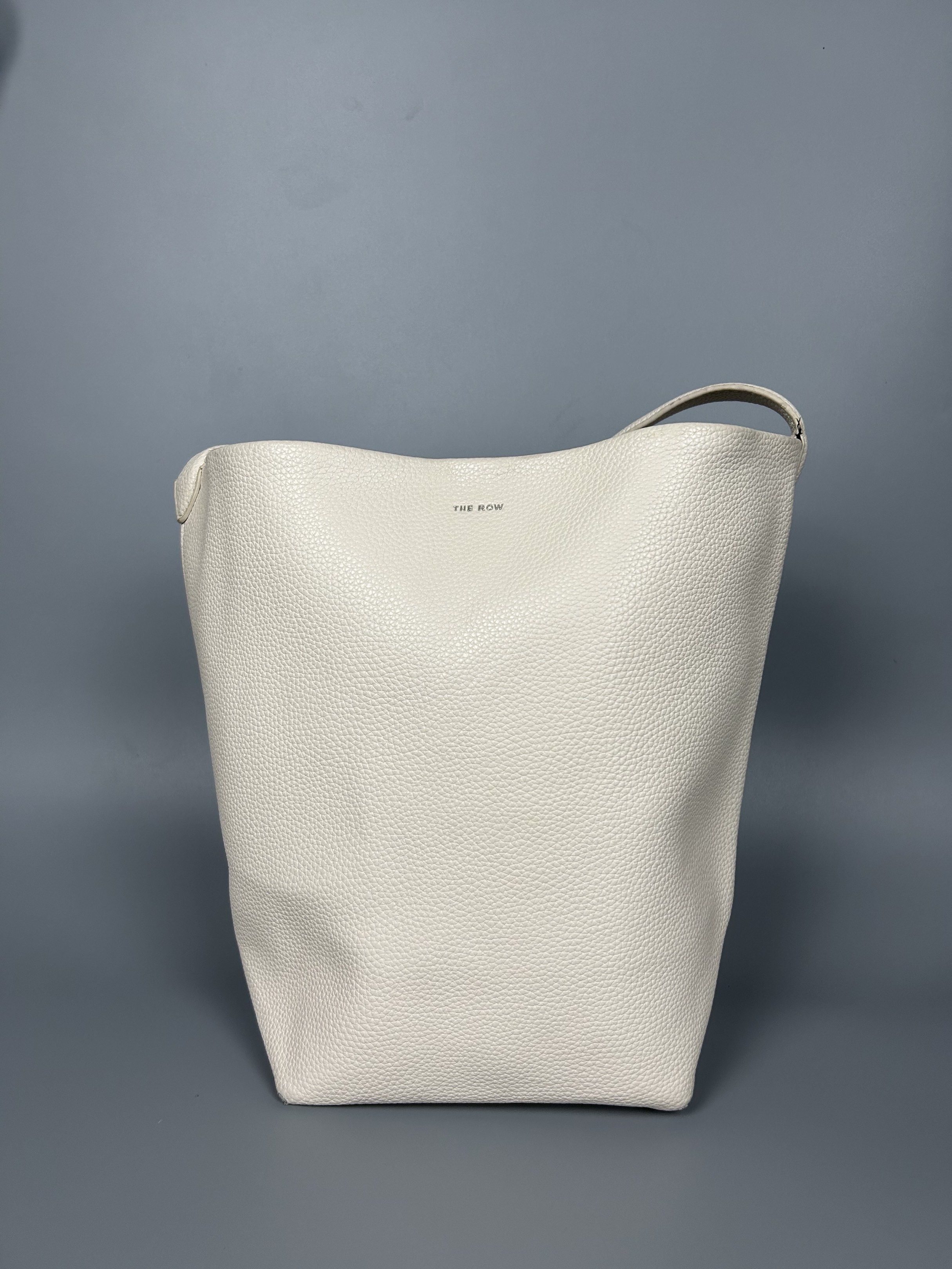 The Row Leather NS Park Bag (Category: Luxury Bags & Wallets) located in Manila. Submitted by 3rdealz (Listing ID 1427321599, Image 1). Description: The row Used condition Courier: J&T or Lalamove Item will be posted by express shipping (J&T) with good tracking record in 1-3 business days after received cleared payment. Expect it to reach you in 3-7 business days only after item been shipped. Please check my other listings and take advantage of c