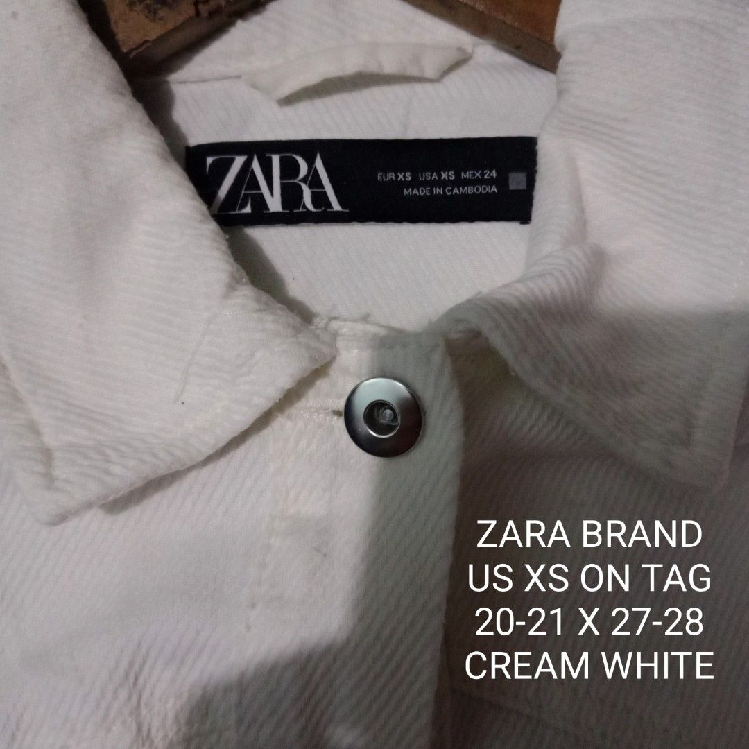 Zara Cream White Denim Jacket XS (Category: Coats, Jackets and Outerwear) located in Silang. Submitted by densrodrig08604 (Listing ID 1427375123, Image 3). Description: Cream white denim jacket from Zara. Features a button-down front, a single chest pocket, and a raw hem. The jacket is made in Cambodia. Size XS. Measurements are approximately 20-21 inches across the chest and 27-28 inches in length. excellent condition no issue,needwash only paym