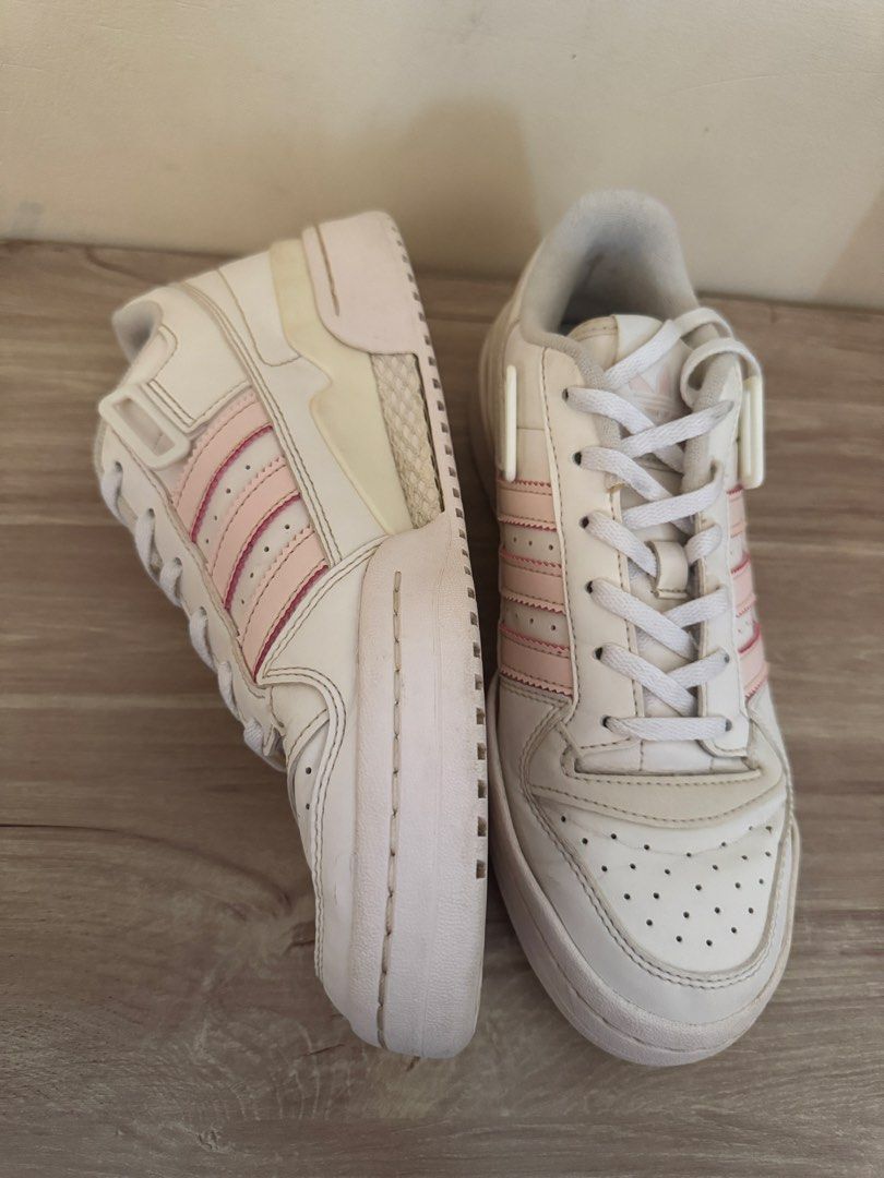 Adidas Forum Low White Pink Sneakers (Category: Sneakers) located in Taytay. Submitted by darkswan016 (Listing ID 1424240868, Image 2). Description: Adidas Forum Low sneakers in white with pink stripes. Features a lace-up closure and a strap. The size is US 8.5. Made in Indonesia. The shoes have some signs of wear on the soles and uppers..